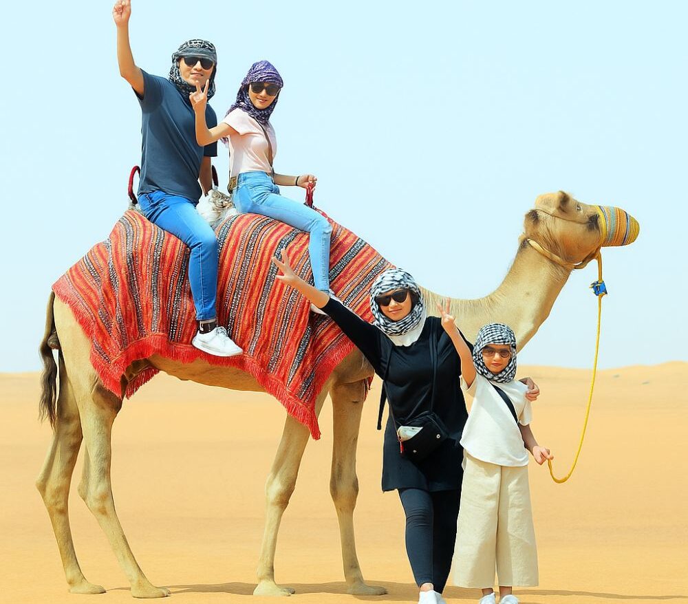 family-enjoying-desert-safari-camel-ride