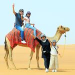 family-enjoying-desert-safari-camel-ride