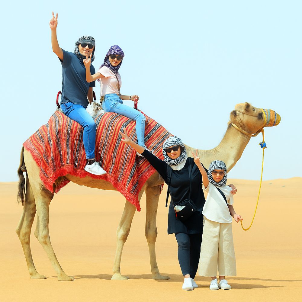 family-enjoying-desert-safari-camel-ride