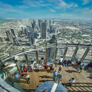group-of-tourists-enjoying-dubai-city-view-from-at-the-top-124-floor-in-burj-khalifa
